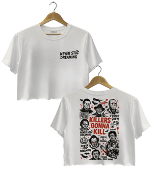 White crop top with 'NEVER STOP DREAMING' in bold black font on the front, and 'KILLERS GONNA KILL' with horror movie character illustrations on the back, including famous villains like Jason and Ghostface.