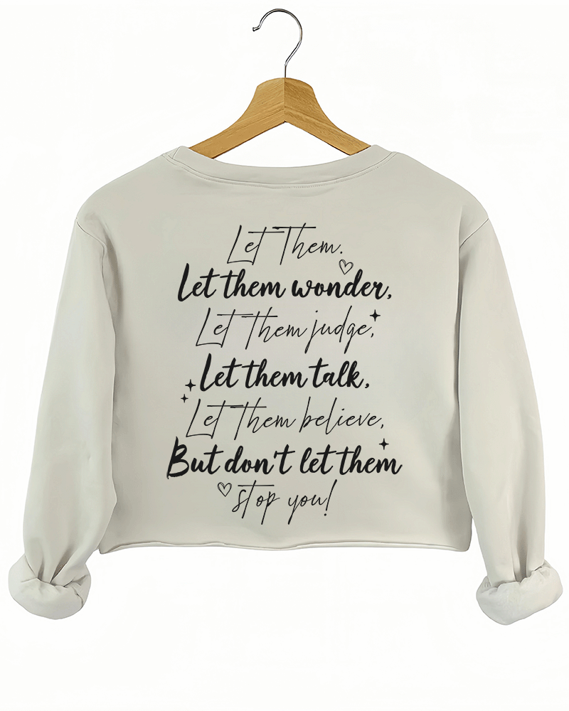 Ragglo beige women's crop sweatshirt back featuring the motivational text 'Let Them Wonder, Let Them Judge, Let Them Talk, Let Them Believe, But Don’t Let Them Stop You!' with a heart in an inspiring graphic design.