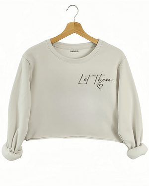 Ragglo beige women's crop sweatshirt front featuring the text 'Let Them' with a small heart in an empowering minimalist design.