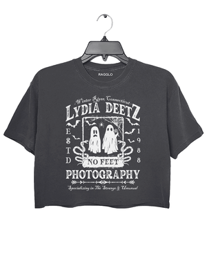 Ragglo dark gray crop top with "Lydia Deetz Photography No Feet" graphic featuring two ghosts, inspired by Beetlejuice with a gothic and supernatural theme.

