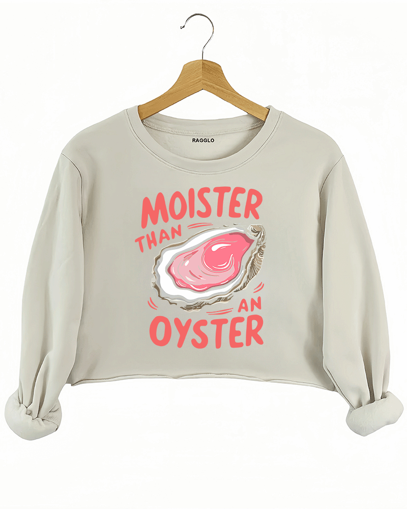 Ragglo beige crop sweatshirt featuring 'MOISTER THAN AN OYSTER' text with an oyster graphic, perfect for cheeky streetwear and playful, flirty vibes.
