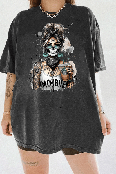 Ragglo MomBae Day of the Dead T-Shirt featuring a stylish sugar skull woman with a headscarf, holding a coffee cup, and wearing a 'MomBae' top with tattoo-inspired splashes, in a humorous and trendy Dia de los Muertos graphic design