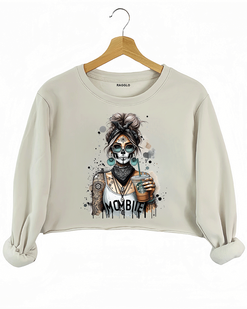 Ragglo MomBae Day of the Dead crop sweatshirt featuring a stylish sugar skull woman with a headscarf, holding a coffee cup, and wearing a 'MomBae' top with tattoo-inspired splashes, in a humorous and trendy Dia de los Muertos graphic design