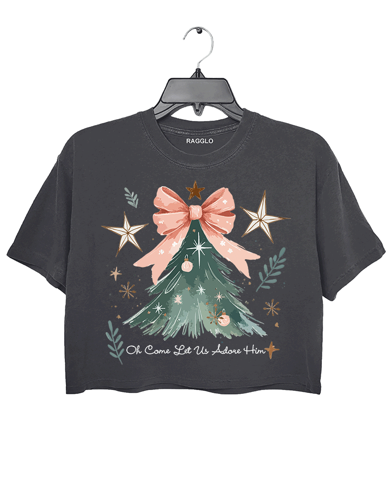 Ragglo dark gray crop top featuring a Christmas tree with a pink bow, stars, snowflakes, and branches, with 'Oh Come Let Us Adore Him' text, perfect for religious Christmas streetwear.



