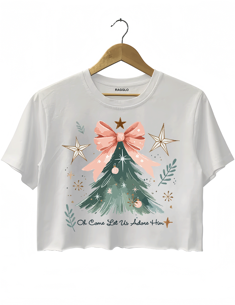 Ragglo white crop top featuring a Christmas tree with a pink bow, stars, snowflakes, and branches, with 'Oh Come Let Us Adore Him' text, perfect for religious Christmas streetwear.





