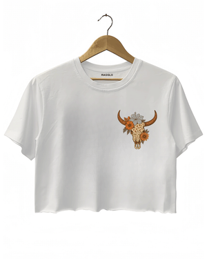 White crop top featuring a bull skull design with floral details on the front. The graphic is in a contrasting warm orange tone, giving it a bold look.