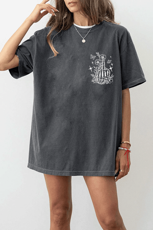 Ragglo dark gray tee front view featuring a skeleton hand with a middle finger gesture surrounded by flowers, butterflies, and stars, perfect for bold streetwear style.

