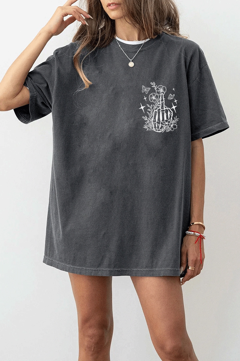 Ragglo dark gray tee front view featuring a skeleton hand with a middle finger gesture surrounded by flowers, butterflies, and stars, perfect for bold streetwear style.

