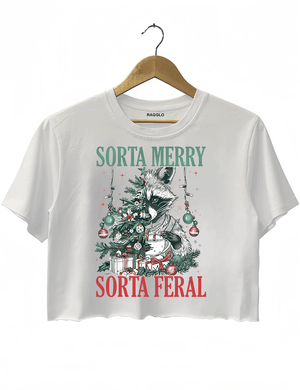 Ragglo white crop top featuring a raccoon with a decorated Christmas tree, gifts, and 'SORTA MERRY SORTA FERAL' text, perfect for funny Christmas streetwear.

