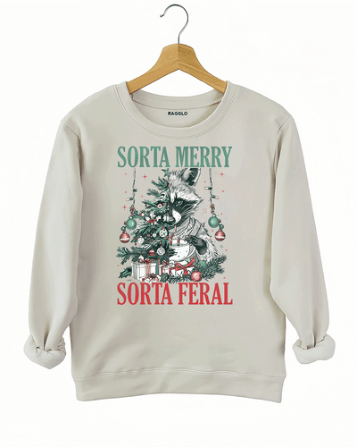 Ragglo beige sweatshirt featuring a raccoon with a decorated Christmas tree, gifts, and 'SORTA MERRY SORTA FERAL' text, perfect for funny Christmas streetwear.

