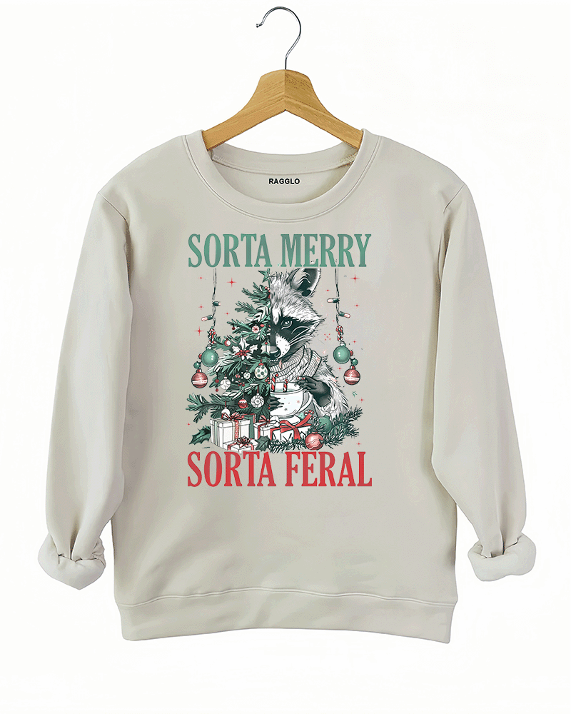 Ragglo beige sweatshirt featuring a raccoon with a decorated Christmas tree, gifts, and 'SORTA MERRY SORTA FERAL' text, perfect for funny Christmas streetwear.

