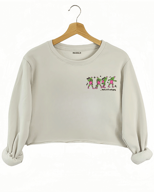 Ragglo beige women's crop sweatshirt front featuring three Grinch characters with Santa hats and the text 'Oh, That’s It I’m Trippin'' in a funny Christmas graphic design.