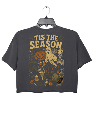 Back view of RAGGLO’s dark gray cropped T-shirt with a large vintage-style Halloween illustration. Includes a jack-o’-lantern, ghost, skeleton, potions, candles, and other mystical elements under the bold text "'TIS THE SEASON." A festive and nostalgic graphic perfect for Halloween lovers.

