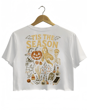 Back view of RAGGLO’s white cropped T-shirt, featuring a vintage Halloween scene with a jack-o'-lantern, ghost, skeleton, potion bottles, and candy, highlighted by the phrase "'TIS THE SEASON" in bold gold letters. A perfect design to capture the spirit of Halloween.

