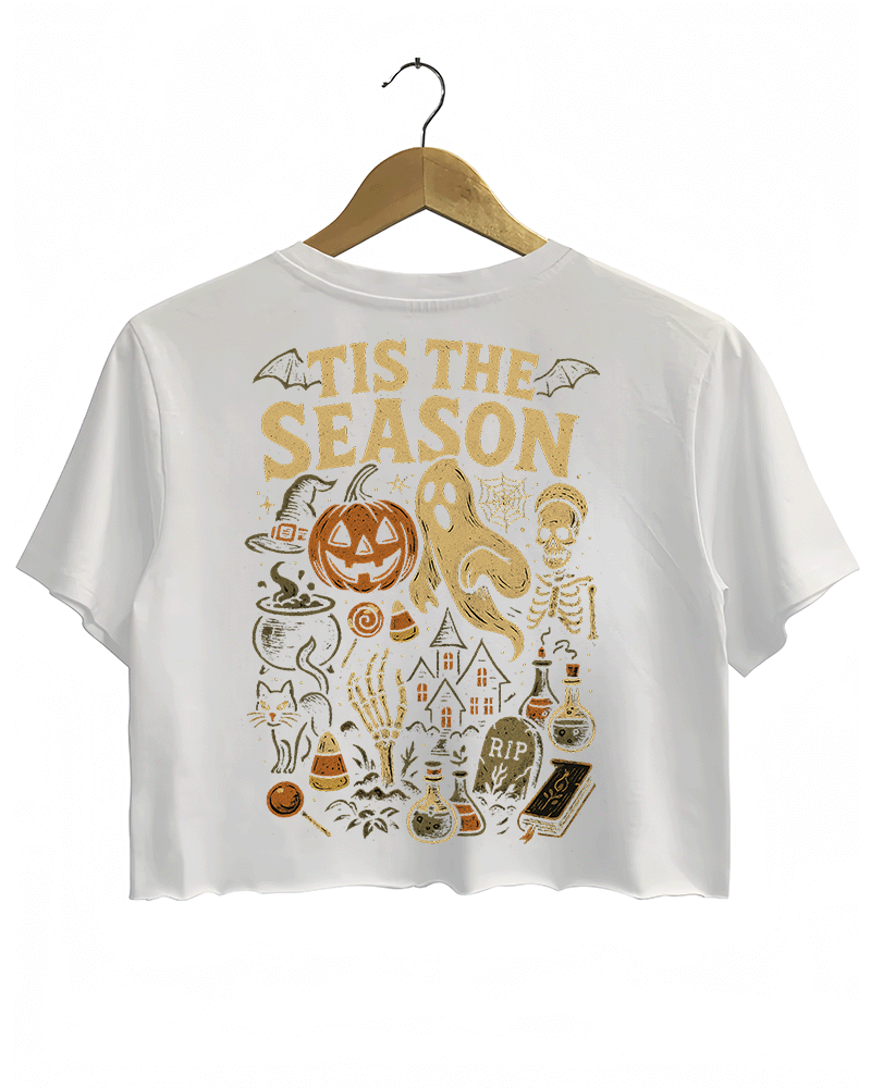 Back view of RAGGLO’s white cropped T-shirt, featuring a vintage Halloween scene with a jack-o'-lantern, ghost, skeleton, potion bottles, and candy, highlighted by the phrase "'TIS THE SEASON" in bold gold letters. A perfect design to capture the spirit of Halloween.

