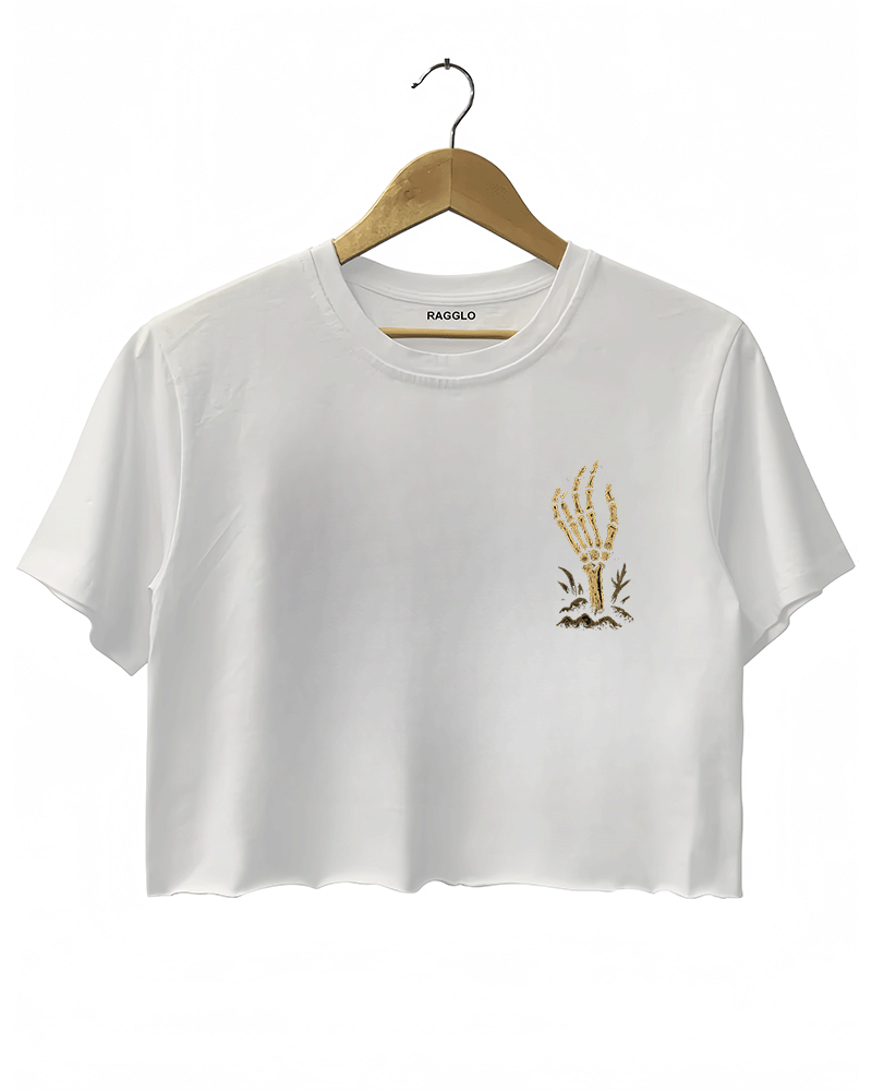 Front view of a white cropped Halloween T-shirt by RAGGLO, with a minimal gold skeleton hand graphic on the left chest, holding a small flame. Simple yet spooky, perfect for a casual Halloween look.