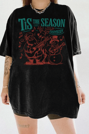 Ragglo black tee featuring Santa, a reindeer, and a snowman playing guitars with musical notes and 'TIS THE SEASON EVERYBODY' text, perfect for festive Christmas streetwear with a musical vibe.

