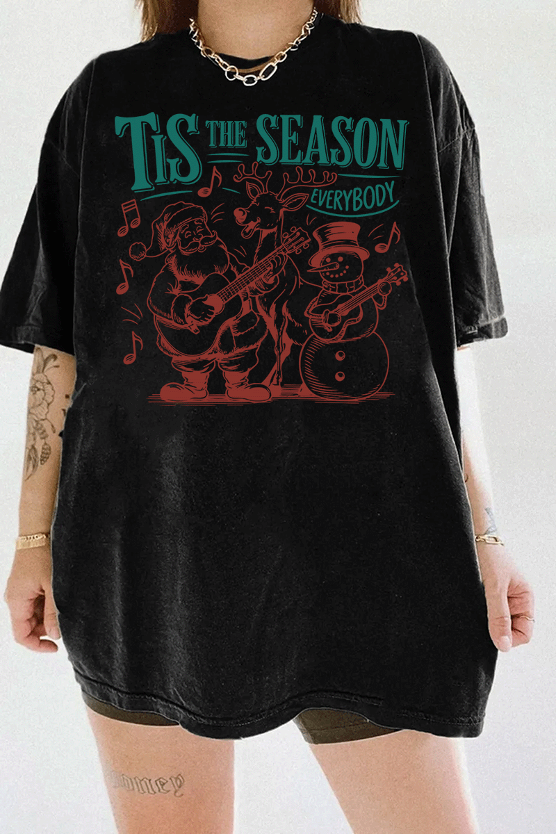 Ragglo black tee featuring Santa, a reindeer, and a snowman playing guitars with musical notes and 'TIS THE SEASON EVERYBODY' text, perfect for festive Christmas streetwear with a musical vibe.


