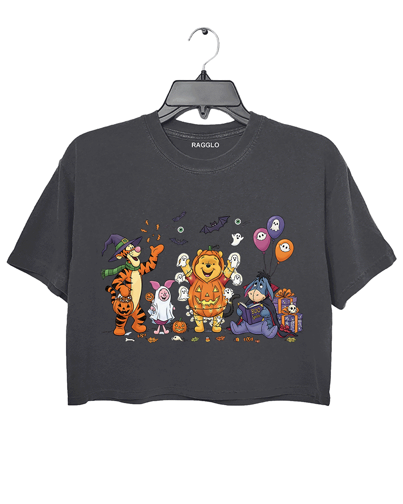 Dark gray cropped Halloween T-shirt by RAGGLO featuring adorable cartoon animals dressed in festive costumes. Includes a tiger in a witch hat, a lion in a pumpkin suit, and a donkey with a ghost-themed gift box. Surrounded by playful ghosts, bats, candy, and Halloween balloons. A charming and cozy tee perfect for spooky season.