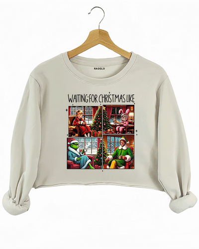 Ragglo beige crop sweatshirt featuring four classic Christmas movie characters waiting by decorated trees with 'WAITING FOR CHRISTMAS LIKE' text, perfect for festive holiday streetwear and movie fans.


