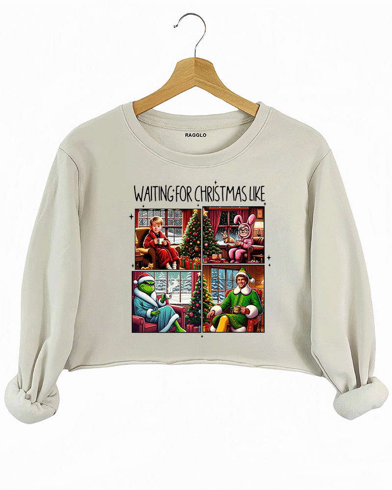Ragglo beige crop sweatshirt featuring four classic Christmas movie characters waiting by decorated trees with 'WAITING FOR CHRISTMAS LIKE' text, perfect for festive holiday streetwear and movie fans.

