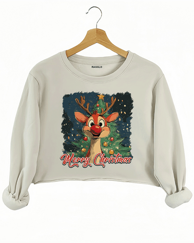 Christmas design featuring a joyful reindeer, a decorated tree, and 'Merry Christmas' text on a beige crop sweatshirt, available on Ragglo.