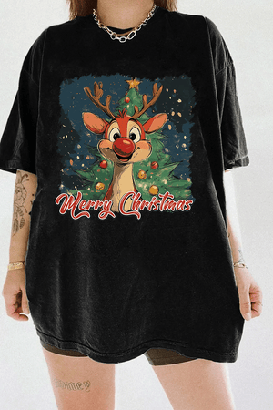 Festive graphic of a red-nosed reindeer in front of a Christmas tree with 'Merry Christmas' text on a black T-shirt, available on Ragglo.