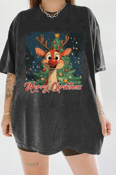 Festive graphic of a red-nosed reindeer in front of a Christmas tree with 'Merry Christmas' text on a dark gray T-shirt, available on Ragglo.