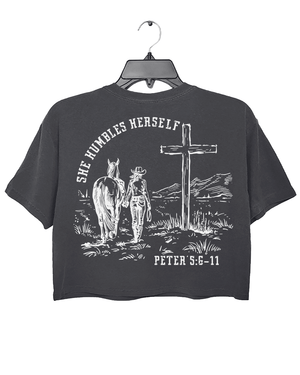 Dark Gray Ragglo women's crop t-shirt with 'She Humbles Herself' text, a cowgirl walking with a horse, a cross, and Peter 5:6-11 scripture, perfect for Christian and western-style apparel

