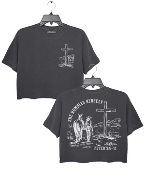 Dark Gray Ragglo women's crop t-shirt featuring front and back designs with 'She Humbles Herself' text, a cowgirl with a horse, a cross, and Peter 5:6-11 scripture, perfect for Christian faith and western-inspired fashion.

