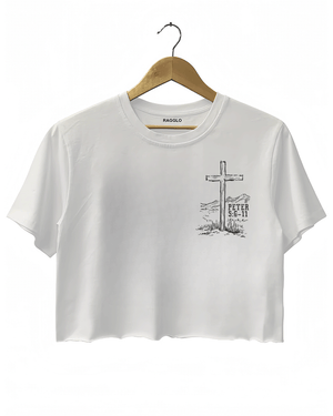 White Ragglo women's crop t-shirt with a cross and 'Peter 5:6-11' scripture in a western landscape, ideal for Christian faith-inspired fashion.

