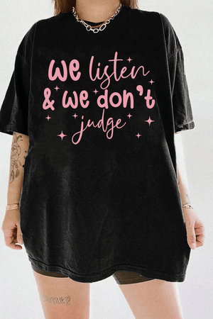 A black t-shirt from Ragglo with the text "We listen & we don't judge" in pink, decorated with star accents.