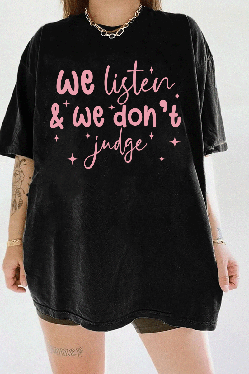 A black t-shirt from Ragglo with the text "We listen & we don't judge" in pink, decorated with star accents.