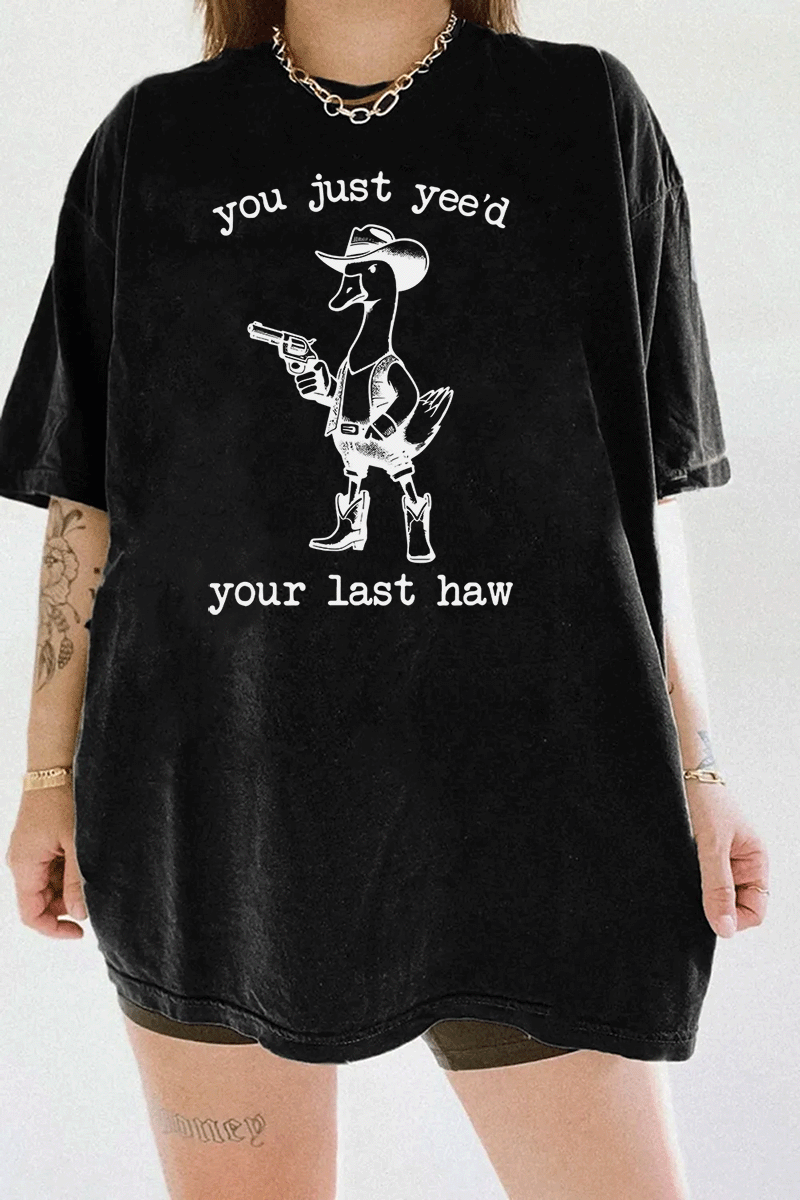 Humorous western duck graphic with a cowboy theme and the text 'You Just Yee’d Your Last Haw' on a black T-shirt, available on Ragglo.