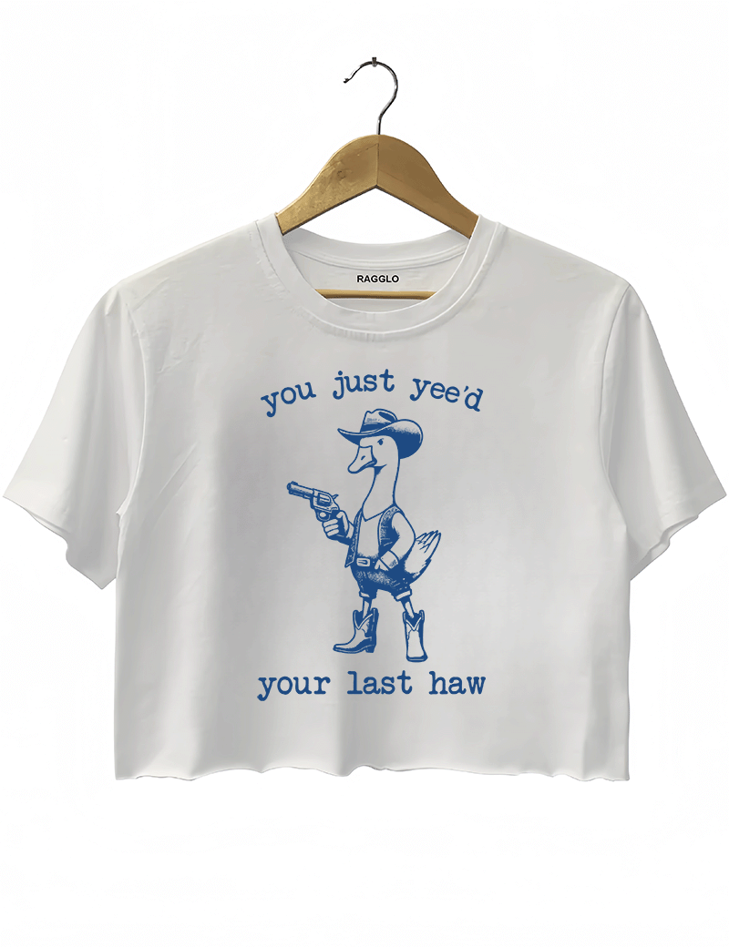 Funny western-themed design with a duck dressed as a cowboy and the text 'You Just Yee’d Your Last Haw' on a white crop top, available on Ragglo.